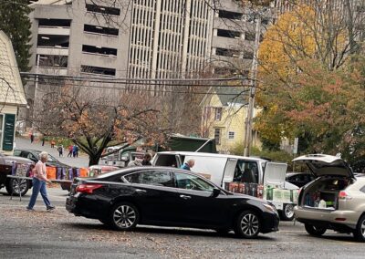 cars driving in to the Trinity Church parking lot to pick up Thanksgiving feasts